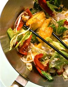 Cabbage stir-fry with pepper, pineapple and sprouts in a wok (2)