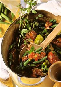 Bean with mince, bacon and tomatoes in a cooking pot