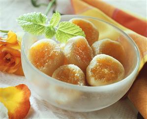 Apricot drops in a bowl with mint leaf