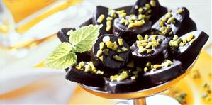 Pistachio sweets in a dish with mint leaf