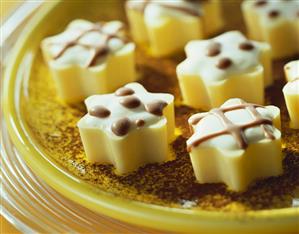 White yoghurt praline stars on a plate