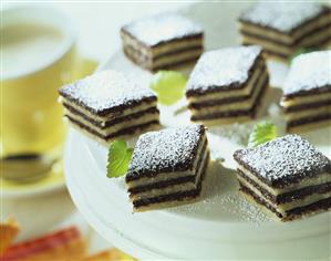 Black and white sweets with icing sugar on a plate