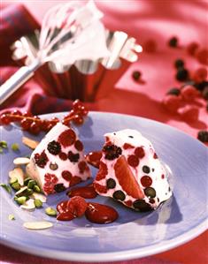 Berry gugelhupf with pistachios on blue plate