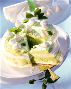 Meringue gateau, a piece cut, with chocolate mint filling