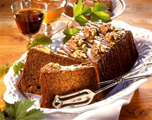 Walnut cake with chocolate icing and chopped pistachios