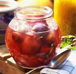 Mustard fruits with almonds in a jar