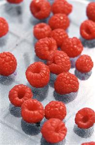 Raspberries on a sheet of glass