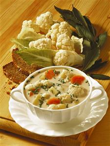 Cauliflower soup with carrots and chives in soup cup