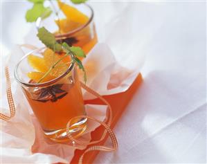 Orange punch jelly with mint leaves in glasses