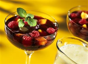 Colourful fruit jelly with berries; frothy champagne sauce