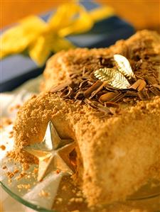 Star-shaped ice cream cake for Christmas with chocolate curls