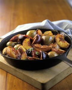 Baked fruits in a pan on a chopping board