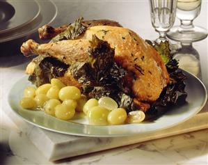 Roast chicken with green grapes and vine leaves