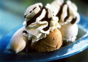 Banana split with cream and chocolate sauce on a plate