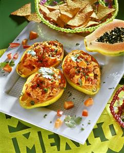 Baked papayas with tomatoes; tortilla chips