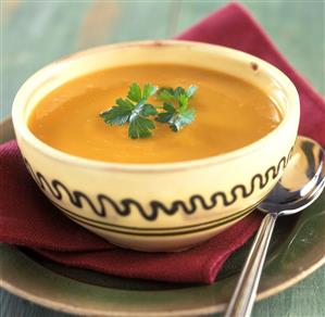 Carrot soup with coriander in a bowl