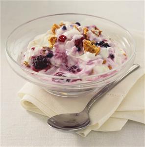 Yoghurt with berries in a glass bowl