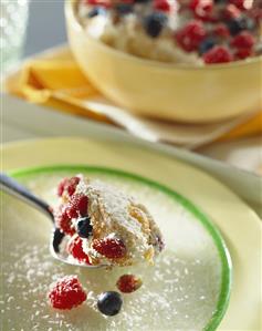 Ricotta mousse with wild strawberries on spoon