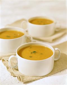 Pumpkin soup in white soup cups
