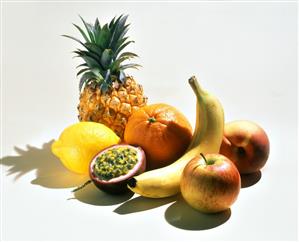 Exotic fruits, apple and peach on a white background