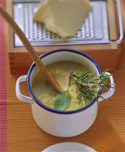 Provencal vegetable soup with fresh herbs in pot