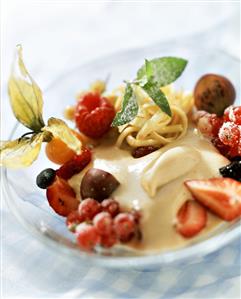 Semolina halva with berries, physalis & mint leaf on plate