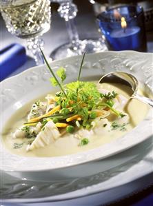 Fish soup with spring vegetables and parsley