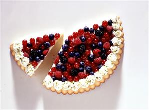 Half a berry tart with individual piece of tart