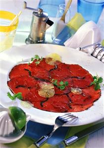 Beef carpaccio with lemon slices and chervil