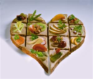 Heart made from open sandwiches with fruit and vegetables