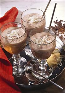 Chocolate shakes with white chocolate curls in glasses