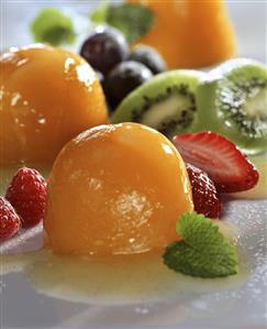 Peach jelly on Moscato sauce, garnished with fruit