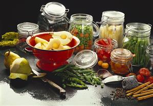 Bottled fruit and vegetables in jars; pears in sieve