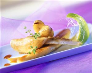 Fried caramelised bananas with wedge of lime