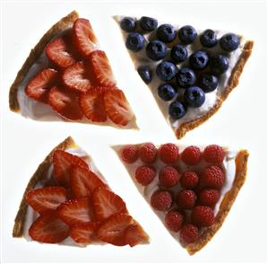 Four pieces of tart strawberry, raspberry and blueberry