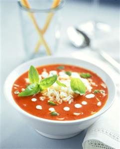 Tomato soup with rice and basil leaves