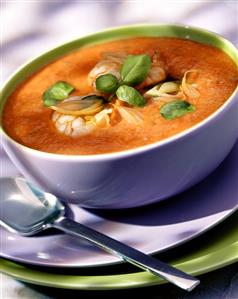 Cold tomato and scampi soup with basil in soup bowl