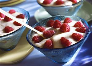 Mascarpone mousse with fresh raspberries in glass bowls