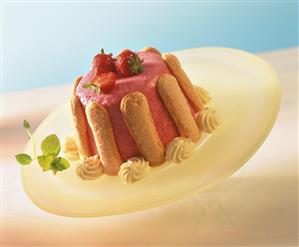 Strawberry charlotte with cream rosette on plate