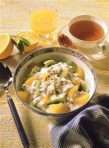 Kiwi fruit and orange muesli, tea and orange juice