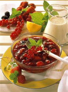 Red berry cream in glass bowl; vanilla milk; Fresh berries