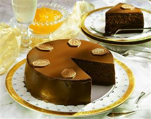 Sacher torte, a piece cut, with piece on plate