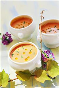 Tomato soup in white soup bowls