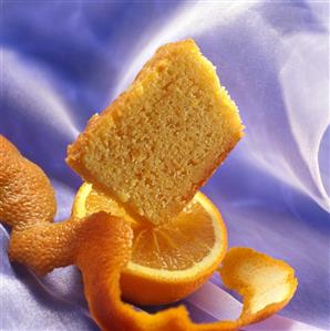 Piece of orange cake on half an orange (1)