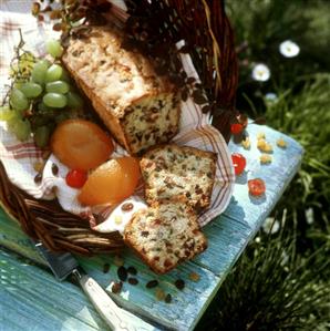 Cake with crystallised fruit in a basket on grass (1)