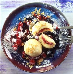 Semolina dumplings with raspberries & flaked almonds