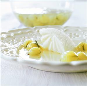 Cold gooseberry soup with ice cream on plate