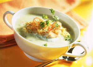 Cream of potato soup with sauerkraut, ham and herbs