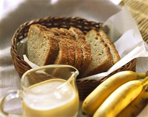 Banana cake with rum sauce; fresh bananas