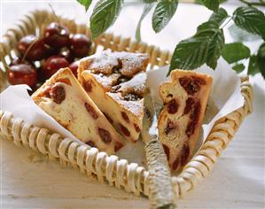 Pieces of cherry quark cake on paper in basket (1)